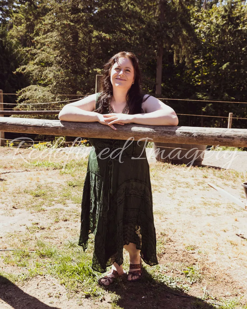 Morgan Nilsen leaning on a wooden fence